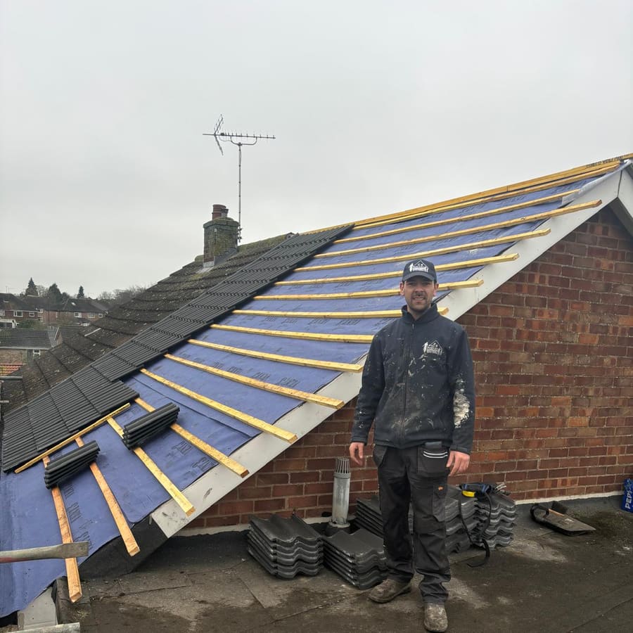 A C R Smith & Son roofer laying new tiles over the battens